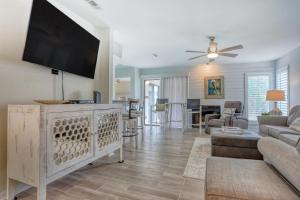 a living room with a large flat screen tv at TOPS'L Tennis Village 48 in Destin