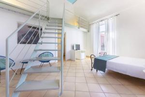 A bed or beds in a room at Palazzo Attila - Gioia Apartments
