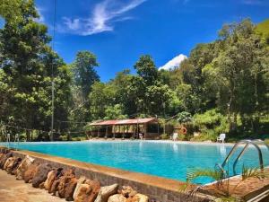 a swimming pool at a resort with mountains in the background at Mount Avangan Eco Adventure Park in Coron