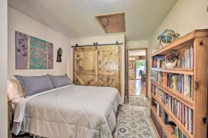 a bedroom with a bed and a book shelf with books at Hugo Home, Direct Lake Access and Private Dock! in Hugo