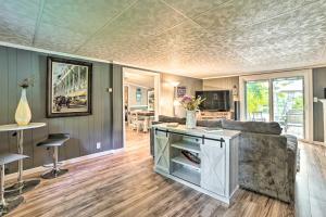 a living room with a couch and a table at Riverfront Home with Dock about 6 Mi to Cheboygan! in Cheboygan