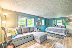 a living room with a couch and a bed at Riverfront Home with Dock about 6 Mi to Cheboygan! in Cheboygan