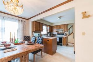 a kitchen with a wooden table and a dining room at Luba's Peaceful Bedroom in Parma