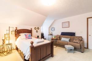 a bedroom with a bed and a couch at Luba's Peaceful Bedroom in Parma