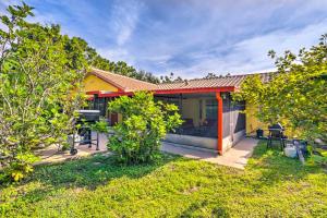 a small yellow house with a yard with trees at North Port Garden Home Florida Room, Lanai! in North Port