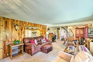 a living room with a couch and a table at Cozy Montana Lake View Getaway - Fish and Hike! in Kalispell