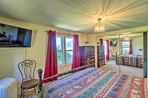 a bedroom with a bed and red curtains at Cozy Montana Lake View Getaway - Fish and Hike! in Kalispell