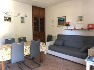 a living room with a couch and a table at Appartamento in Villa Andreina in Orosei