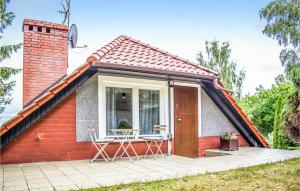 a small red brick house with a patio at Pet Friendly Apartment In Gdansk With Kitchen in Gdańsk