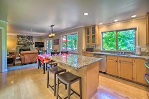 a kitchen with a large island with bar stools at Beautiful Wine Country Home with Hot Tub and Lake View in Woodinville