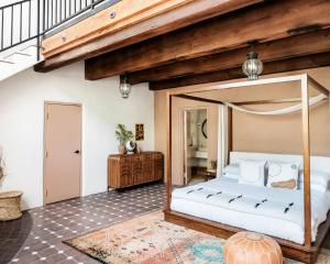 a bedroom with a canopy bed in a room at The JTH Tucson in Tucson