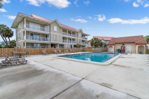 a villa with a swimming pool and a building at Sunset Harbor Palms 1-311 in Navarre