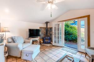 a living room with a couch and a fireplace at Vineyard Cottage in Guerneville