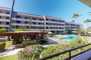 a hotel with a swimming pool and a resort at White Sands Resort #108 in Kailua-Kona