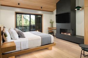 a bedroom with a bed and a fireplace at Desolation Hotel in South Lake Tahoe