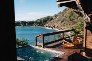 a hot tub on a deck with a view of the ocean at Selá Nicaragua in El Gigante