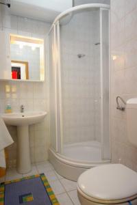a bathroom with a shower and a toilet and a sink at Studio Krk 3231a in Vrh