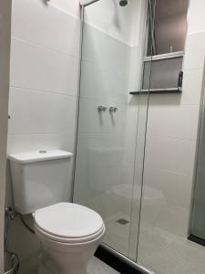 a bathroom with a toilet and a glass shower at prudente 304 in Rio de Janeiro