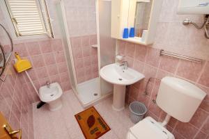 a bathroom with a sink and a toilet and a shower at Apartments with swimming pool Jadranovo, Crikvenica - 3238 in Jadranovo +36 photos