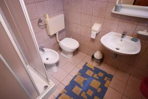 a bathroom with a toilet and a sink at Apartments by the sea Selce, Crikvenica - 3240 in Selce