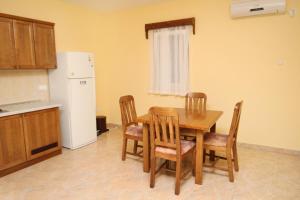 a kitchen with a table and chairs and a refrigerator at Apartments by the sea Rogoznica - 3265 in Rogoznica