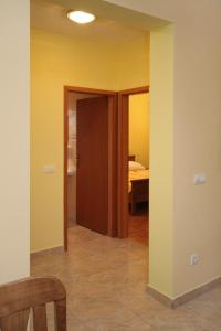 a room with yellow walls and a dining room at Apartments by the sea Rogoznica - 3265 in Rogoznica