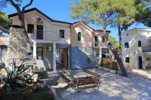 a house with a picnic table in front of it at Double Room Rogoznica 3266a in Rogoznica