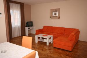 a living room with a couch and a table at Apartments with a parking space Novalja, Pag - 3294 in Novalja