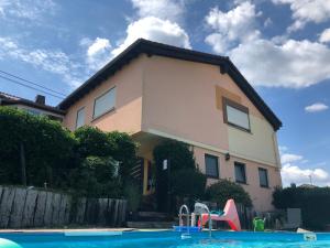 a house with a swimming pool in front of a house at Ferienwohnung Baldus-Westerwald in Mogendorf