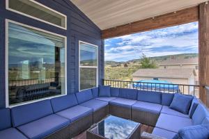 a blue couch on a balcony with a view at Garden City Retreat with Access to Bear Lake! in Garden City