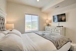 a bedroom with a bed and a tv and a window at Garden City Retreat with Access to Bear Lake! in Garden City +37 photos
