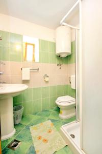 un bagno verde con un water e un lavandino di Family friendly house with a swimming pool Orihi, Central Istria - Sredisnja Istra - 3334 a Barban