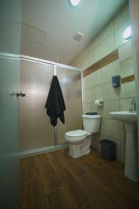 a bathroom with a shower and a toilet and a sink at Hotel Sttiny Monterrey Tecnológico in Monterrey