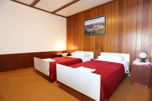 two beds in a room with wood paneling at Rooms by the sea Racisce, Korcula - 3095 in Račišće