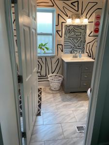 a bathroom with a sink and a mirror at Tremont! 7 min to downtown Cleveland in Cleveland