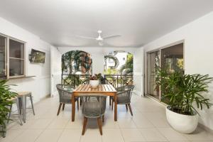 a dining room with a table and chairs at Lantana Lakes - Resort Style Living in Cairns North
