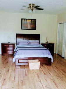 a bedroom with a large bed and two night stands at Tranquil Creekside Mountain View Getaway in Clyde