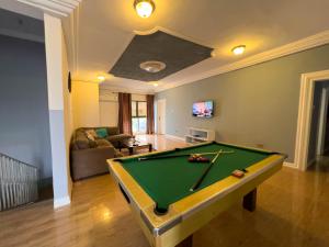 a living room with a pool table in it at T’s place in Apenkwa