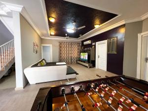 a living room with a pool table and a couch at T’s place in Apenkwa