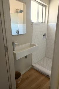 a bathroom with a sink and a shower at Miracle Manor Boutique Hotel & Spa in Desert Hot Springs