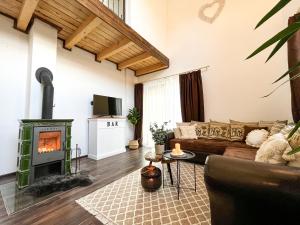 a living room with a couch and a fireplace at Dovolenková chata Valča in Stará Turá