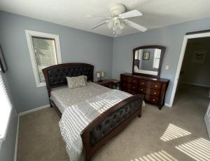 a bedroom with a bed and a dresser and a mirror at Beautiful Private West Knoxville Home 2700sf, 4 Beds, 2 & half Baths in Knoxville