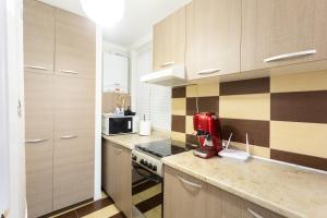 a kitchen with a red mixer on a counter at Central Apartment Targu Mures in Târgu-Mureş +24 photos