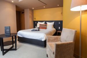 Postel nebo postele na pokoji v ubytování Hotel Restaurant Spa Ivan Vautier
