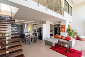 a living room with a couch and a table at Raya Beachloft in Rawai Beach