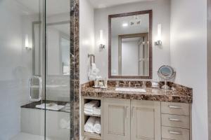 a bathroom with a sink and a mirror and a shower at Premium Three Bedroom in Park City