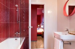 a bathroom with a shower and a sink and a tub at Hotel Boris V. by Happyculture in Levallois-Perret +33 photos