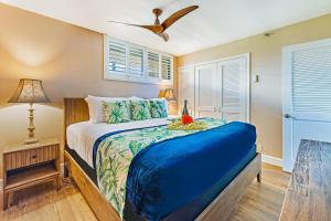 a bedroom with a bed and a ceiling fan at Maui Kai 804 Oceanfront 1 BD 1Ba condo in Kahana +32 photos