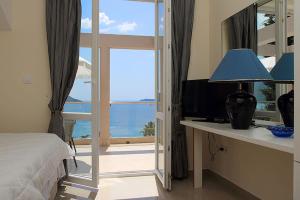 a bedroom with a sliding glass door with a view of the ocean at Swiss Residence Montenegro in Herceg-Novi