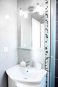 a bathroom with a sink and a mirror at Swiss Residence Montenegro in Herceg-Novi